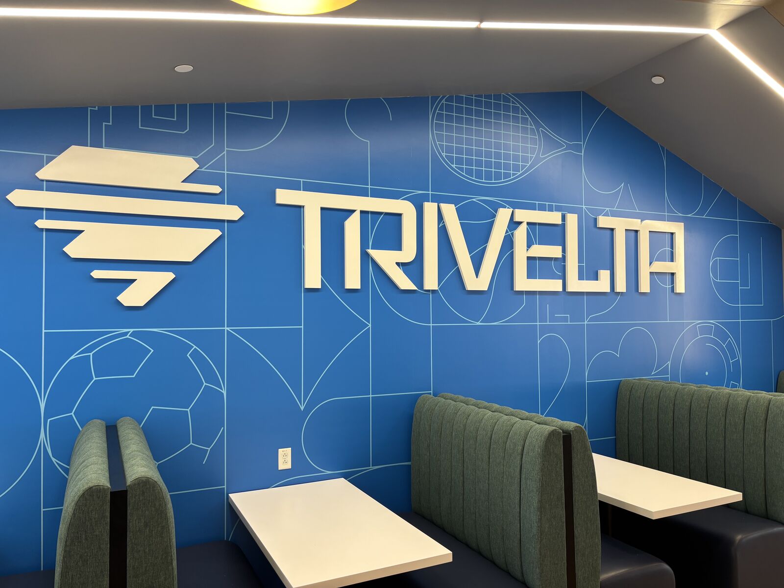 Trivelta logo and booth seating at the Boston office